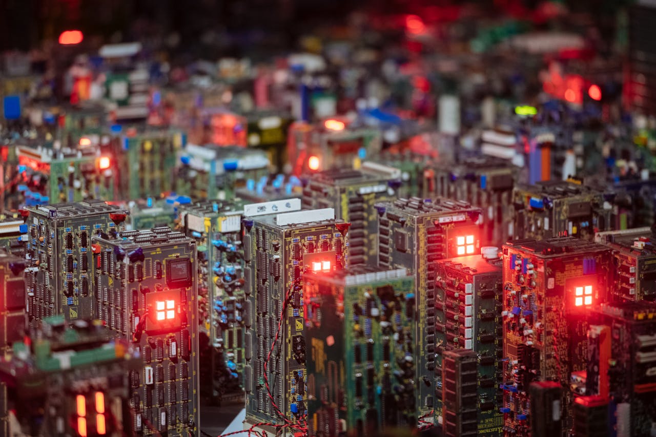 Close-up view of illuminated circuit boards resembling a cityscape, showcasing intricate electronic design.